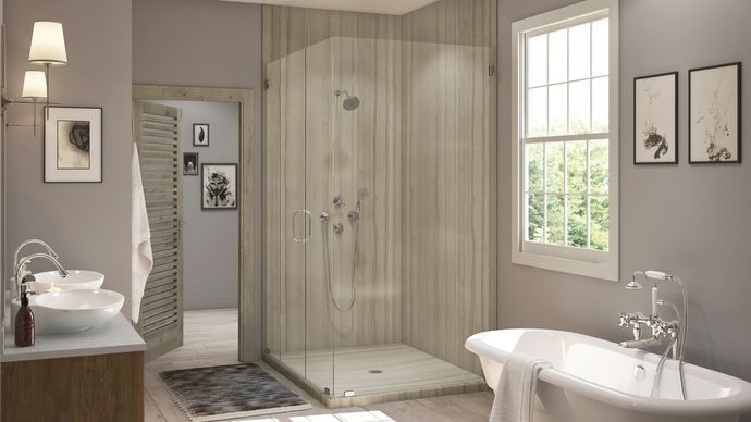 A bathroom with a walk in shower , tub , sink and window.