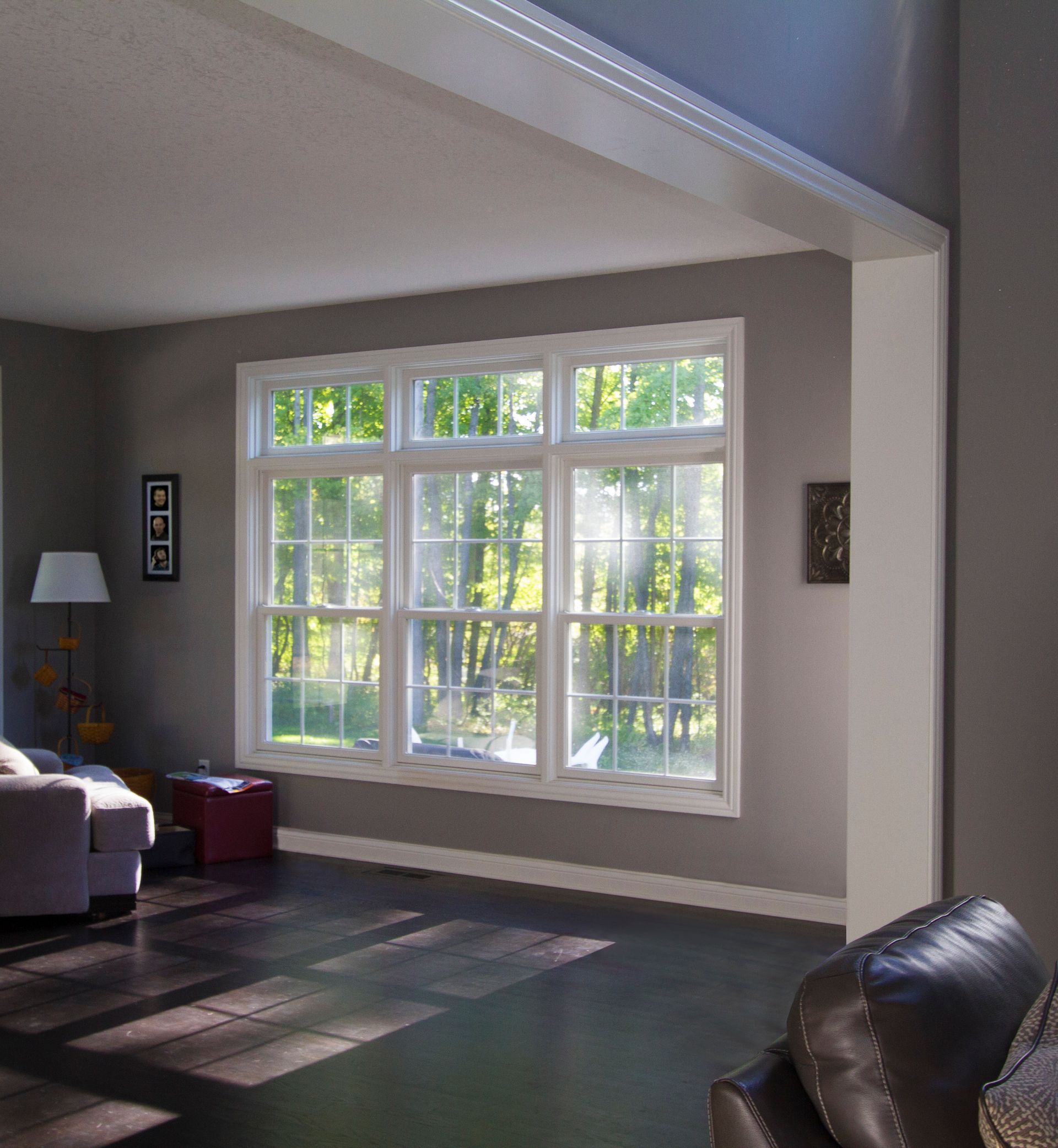 A living room with a lot of windows and a couch