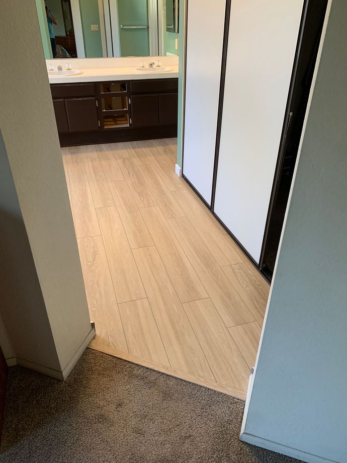 A bathroom with hardwood floors and a sink.