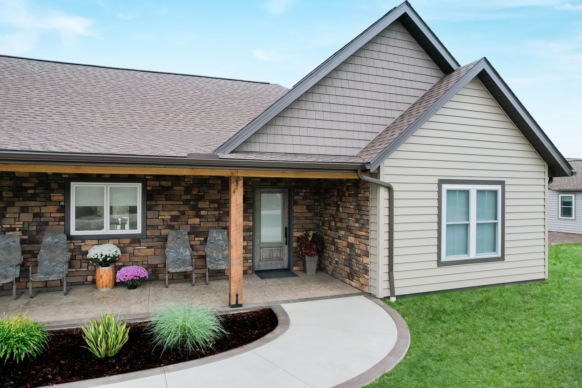 A house with a porch and a walkway leading to it.