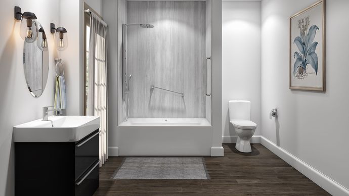 A bathroom with a tub , toilet , sink and mirror.