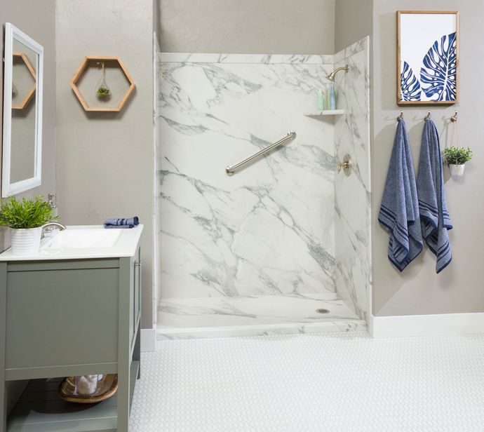 A bathroom with a walk in shower and a sink.