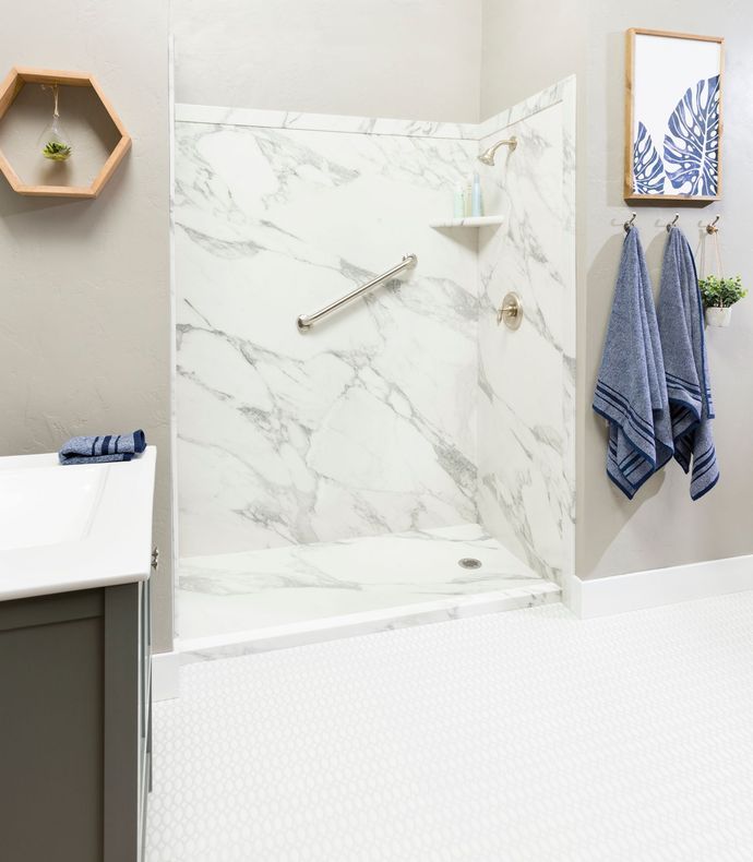 A bathroom with a walk in shower and a sink.