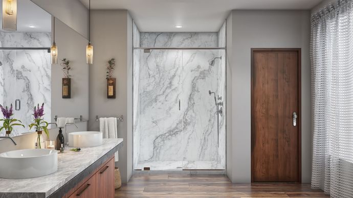 A bathroom with marble walls and a walk in shower.