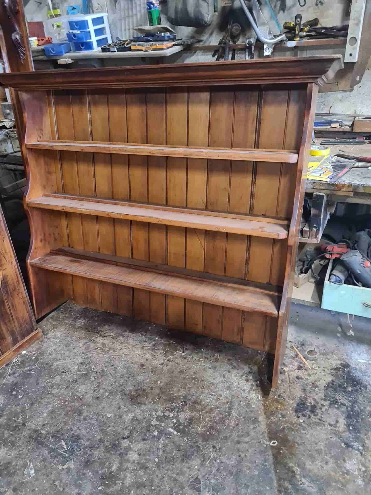 A Wooden Shelf is Sitting on the Floor in a Workshop — The Restoration Barn In Te Kowai, QLD