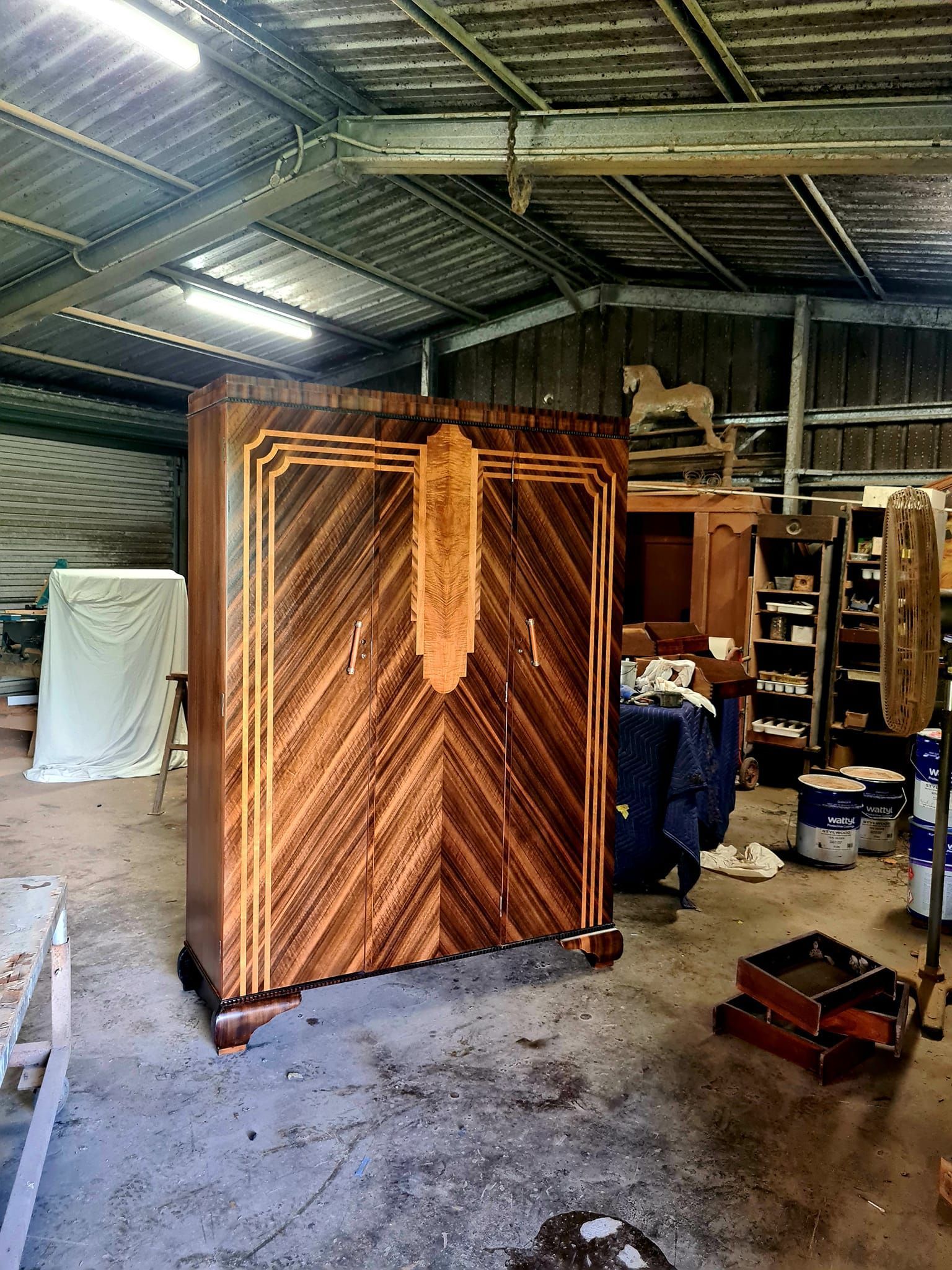 A large wooden cabinet is sitting in a warehouse — The Restoration Barn In Te Kowai, QLD