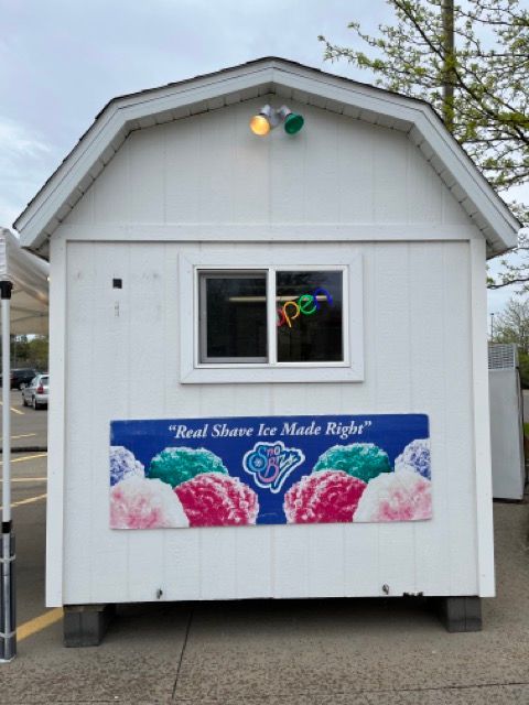 A white building with a sign that says 