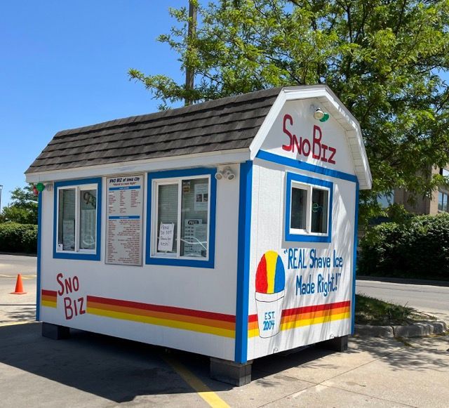 A small building that says sno biz on it