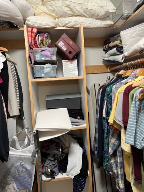 A closet filled with lots of clothes and shoes