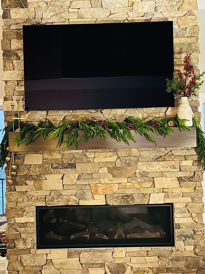 A fireplace with a flat screen tv above it.