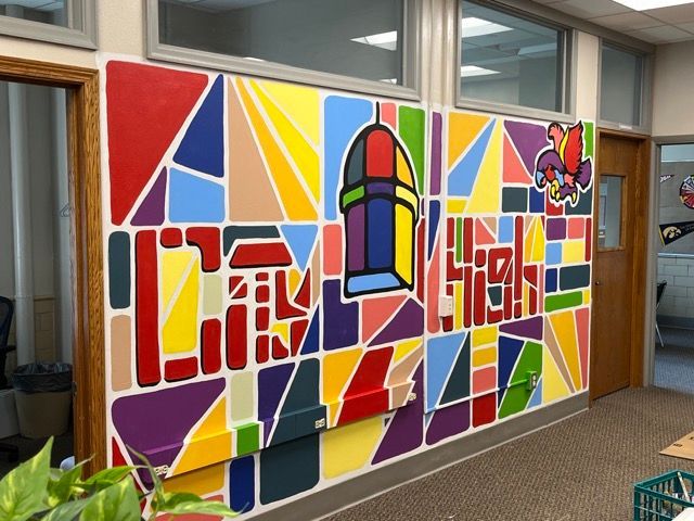 A colorful mural on a wall that says city high