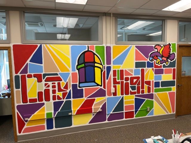 A mural on a wall that says city high