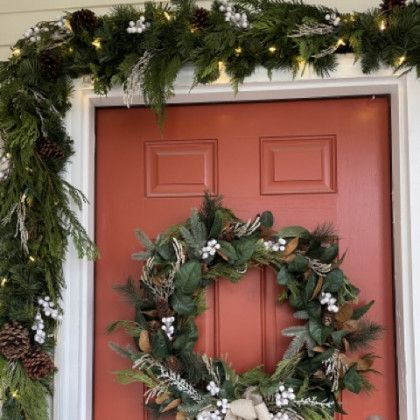 A red door with a christmas wreath on it