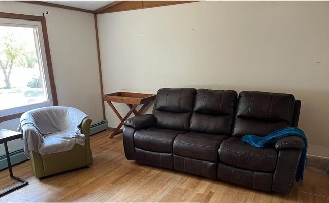 A living room with a couch and a chair