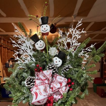 A bouquet of christmas decorations with snowmen and pine cones