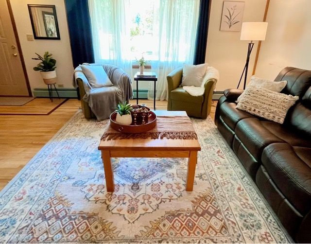 A living room with a couch and chairs and a coffee table