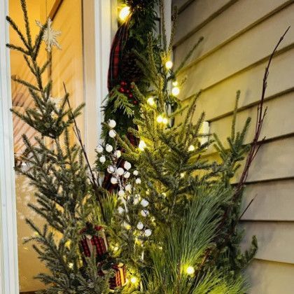 A christmas tree is sitting in front of a window.
