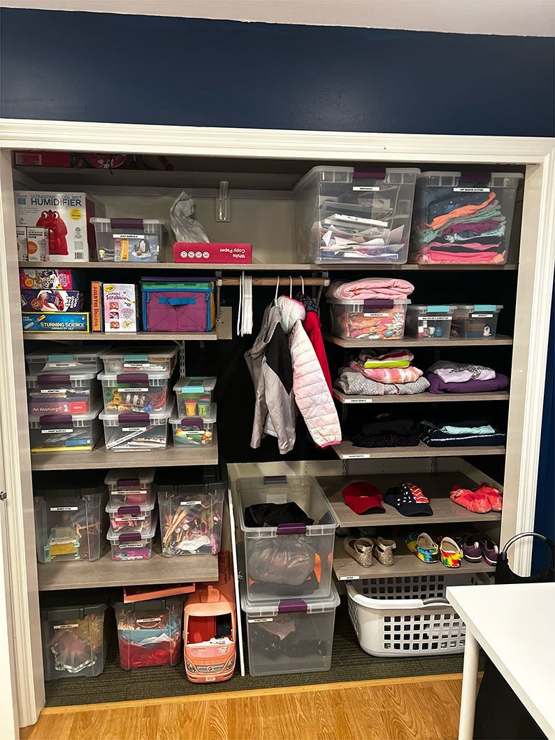 A closet filled with lots of clothes and toys.
