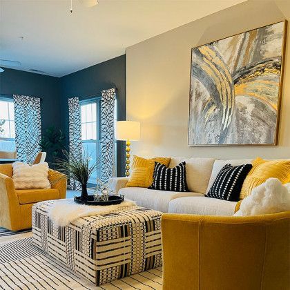 A living room filled with furniture and a painting on the wall.