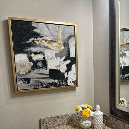 There is a painting on the wall above the sink in the bathroom.