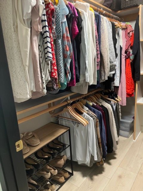 A walk in closet filled with clothes and shoes