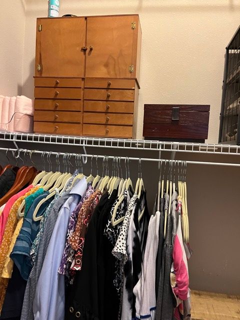 A closet filled with clothes and a jewelry box