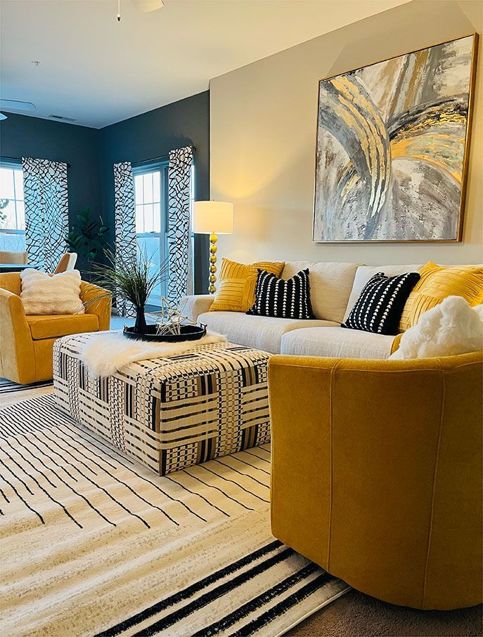 A living room filled with furniture and a painting on the wall.