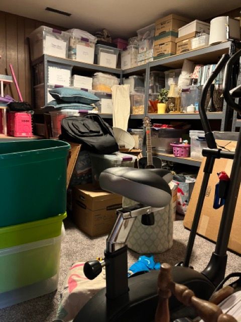 A cluttered room with boxes and a bicycle in it