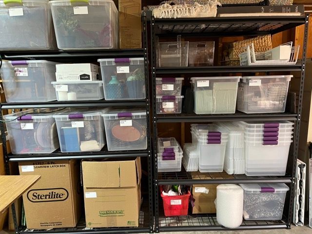A shelf filled with lots of plastic bins and boxes.