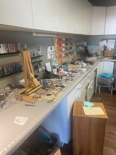 A messy kitchen with a lot of items on the counter.