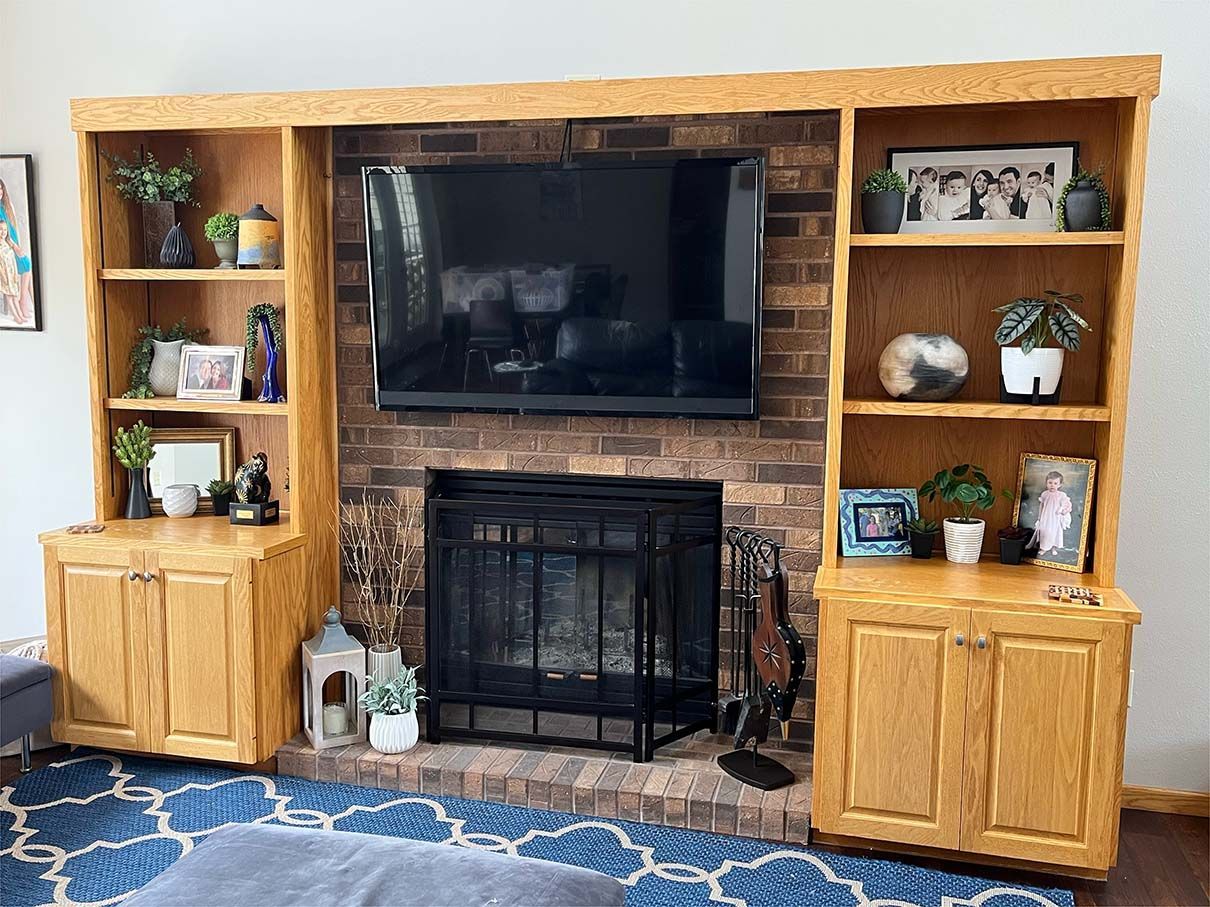 A living room with a fireplace and a flat screen tv.