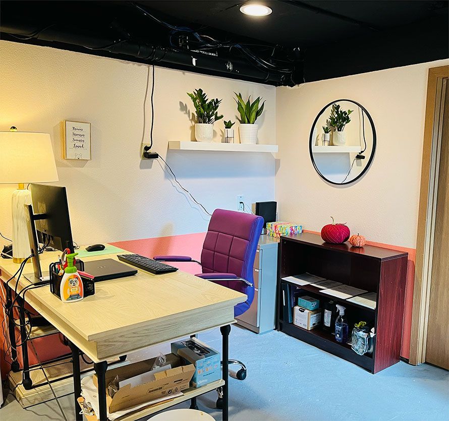 A room with a desk and chair and a computer on it