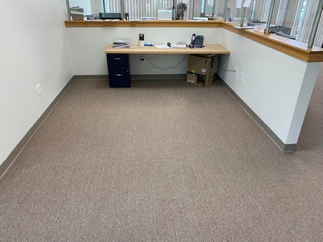 An empty office with a desk and a window