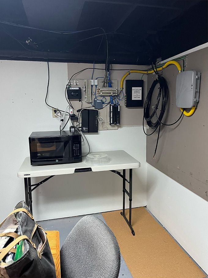 A microwave oven is sitting on a table in a room.