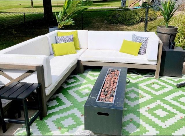 A patio with a couch and a fire pit