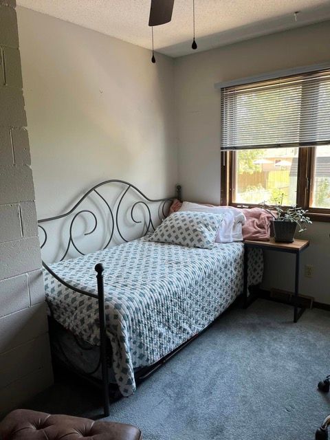 A bedroom with a single bed and a window
