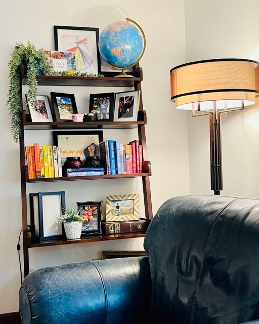 A living room with a globe on top of a bookshelf