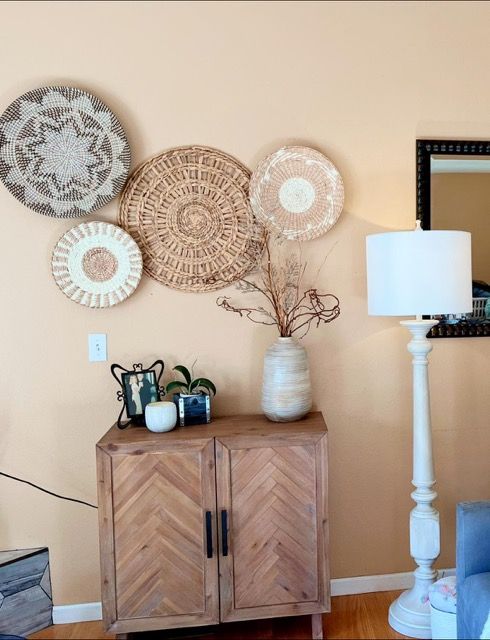 A living room with a wooden cabinet and a lamp