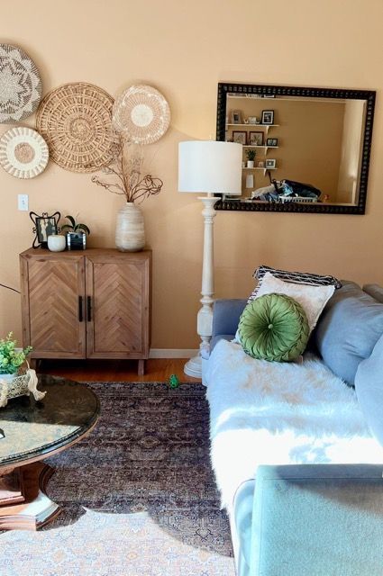 A living room with a couch and a mirror