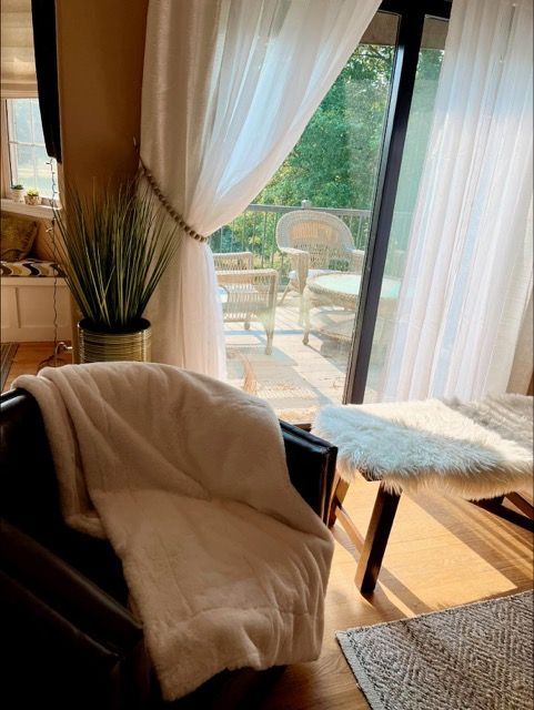 A living room with a chair and a blanket on it