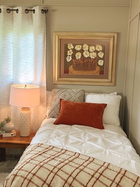 There is a picture of flowers on the wall above the bed.