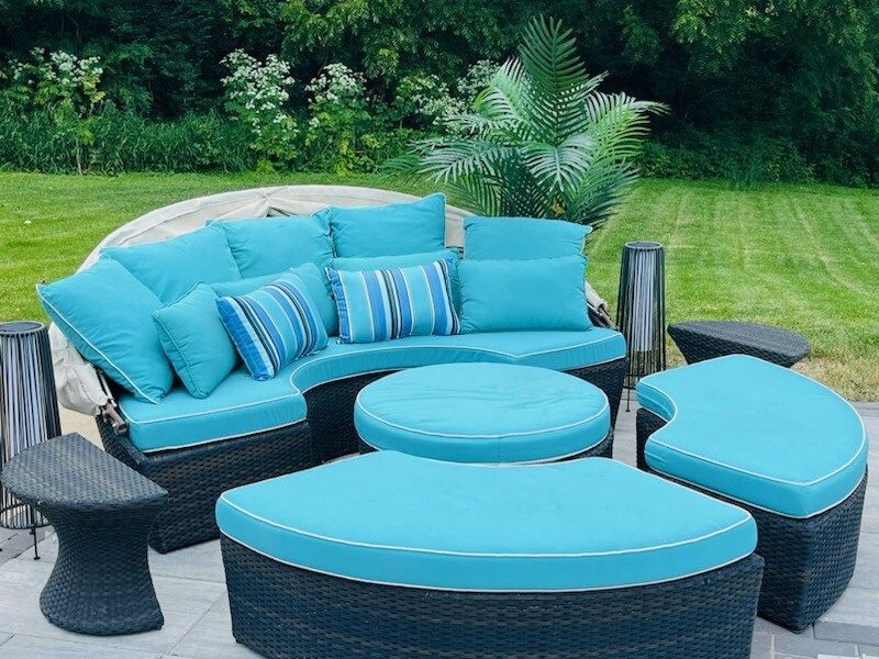 A patio set with blue cushions and pillows