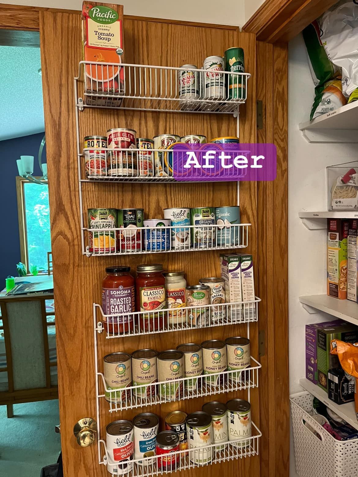 A pantry with a bunch of cans and jars hanging on a door.