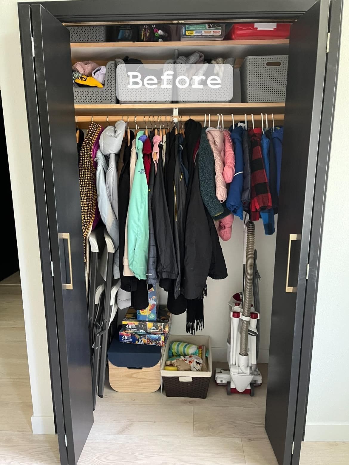 A before picture of a closet filled with clothes and a vacuum cleaner.