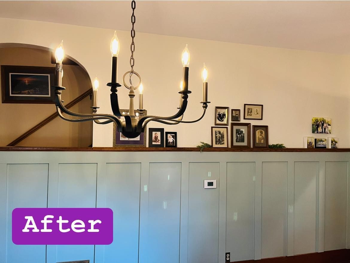 A dining room with a chandelier hanging from the ceiling and a sign that says after