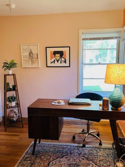 A room with a desk and chair and a lamp