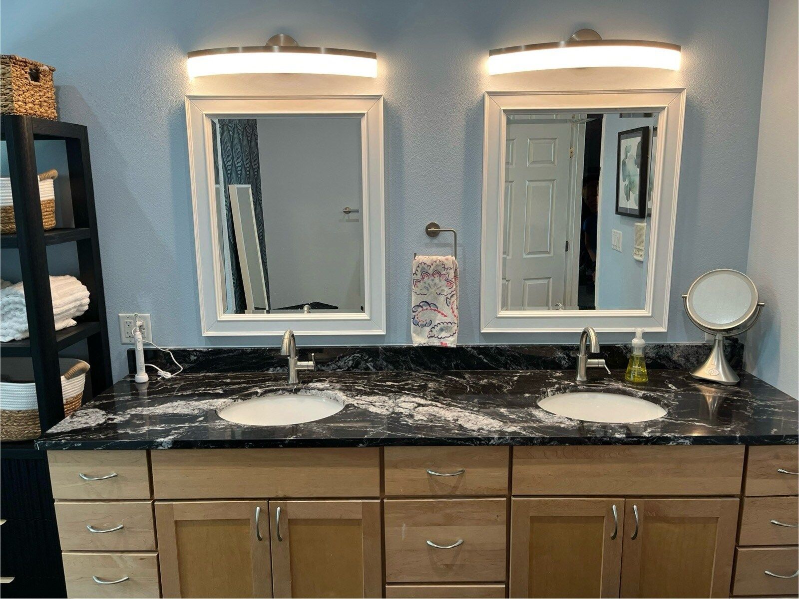 A bathroom with two sinks and two mirrors.