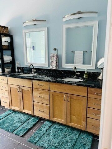 A bathroom with two sinks and two mirrors.
