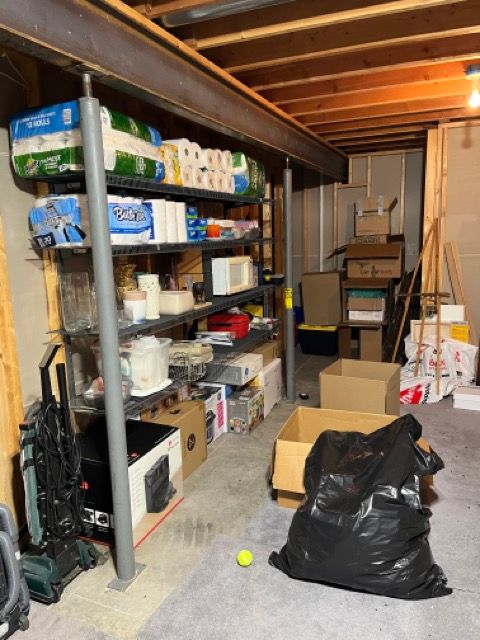 A bunch of boxes and shelves in a room with a ball on the floor