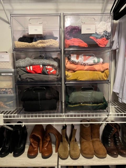 A closet filled with lots of clothes and shoes.